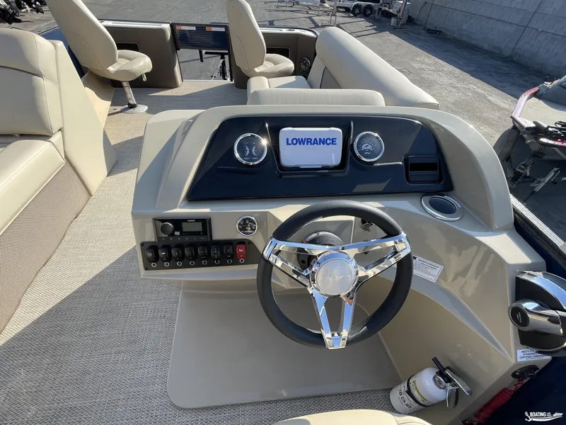 Slide: The Image of 2023 Crest 200 Classic Fish boat interior with steering wheel and Lowrance display. - 9