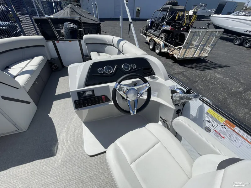 Slide: The Image of 2023 Crest 220 LX Classic SLS boat interior with steering console and seating. - 3