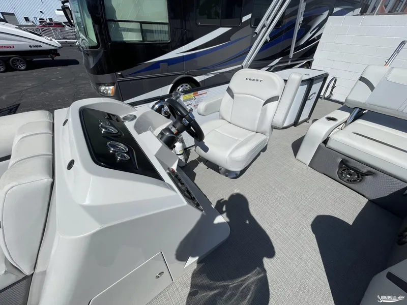 Slide: The Image of 2023 Crest 220 LX Classic SLS boat interior with steering console and seating. - 4