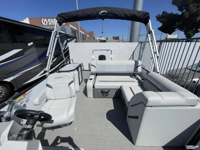 Slide: The Image of 2023 Crest 220 LX Classic SLS pontoon boat with spacious seating and modern design. - 5