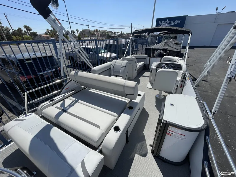 Slide: The Image of 2023 Crest 220 LX Classic SLS pontoon boat with spacious seating and modern amenities. - 7