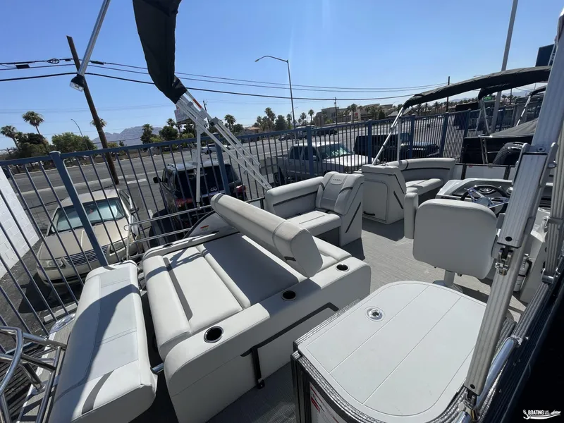 Slide: The Image of 2023 Crest 220 LX Classic SLS pontoon boat interior with seating and steering console. - 9