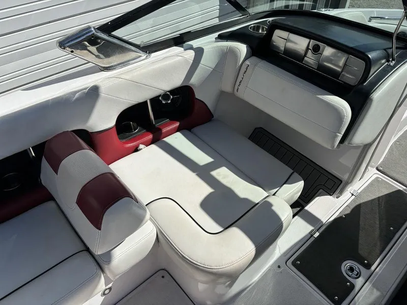 Slide: The Image of Interior of a 2010 Nautique Super Air Nautique 226 boat with white and red seating. - 5