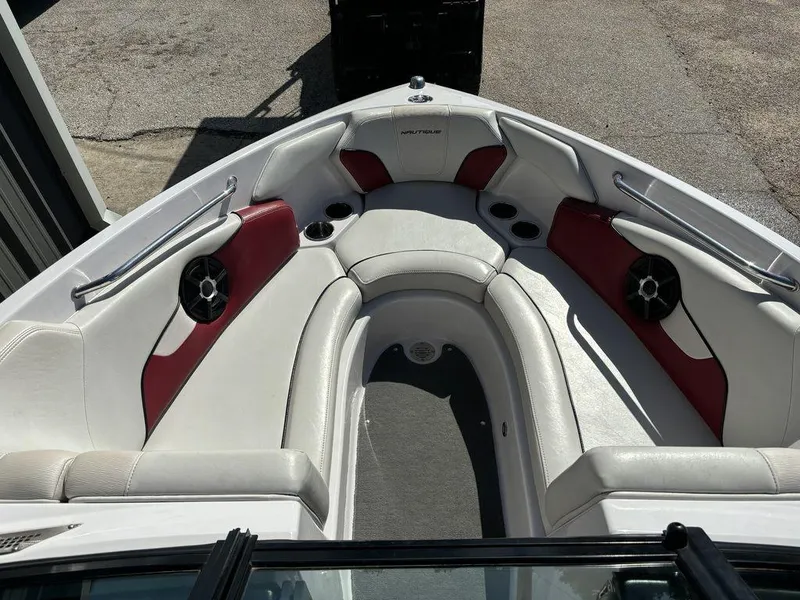 Slide: The Image of 2010 Nautique Super Air Nautique 226 boat interior with white and red seating. - 7