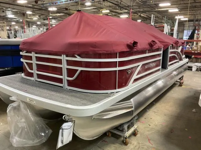 Slide: The Image of 2024 Bennington 22 SVSR-SPS pontoon boat with red cover in a warehouse. - 3