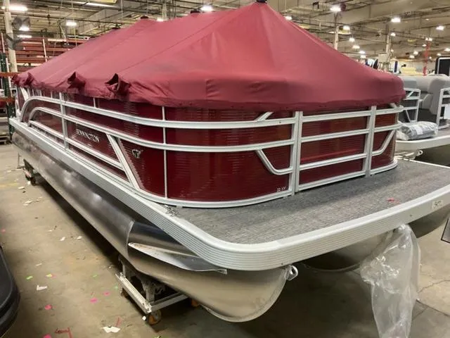 Slide: The Image of 2024 Bennington 22 SVSR-SPS pontoon boat with red cover in a warehouse. - 4
