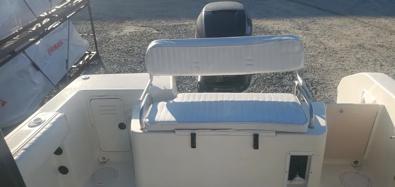 Slide: The Image of 2000 Robalo 2240 Walkaround boat interior with cushioned seating and outboard motor. - 10