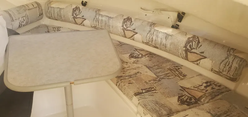 Slide: The Image of Interior of 2000 Robalo 2240 Walkaround with patterned seating and table. - 13