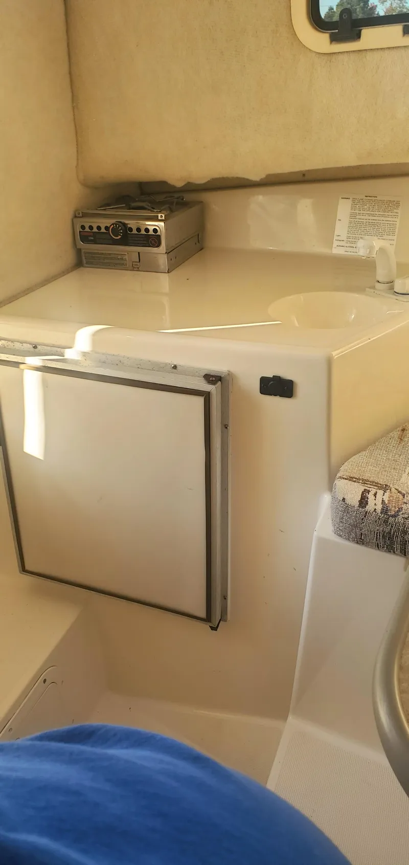 Slide: The Image of Interior of 2000 Robalo 2240 Walkaround boat with compact kitchen area. - 14