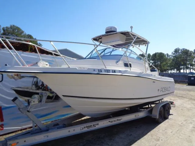 Slide: The Image of 2000 Robalo 2240 Walkaround boat on a trailer in a sunny outdoor setting. - 16