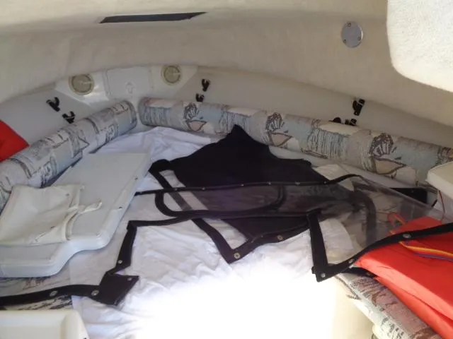 Slide: The Image of Interior cabin of a 2000 Robalo 2240 Walkaround boat with cushions and gear. - 25