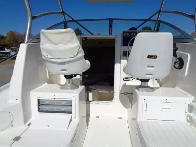 Slide: The Image of 2000 Robalo 2240 Walkaround boat interior with helm seats and cabin entrance. - 26