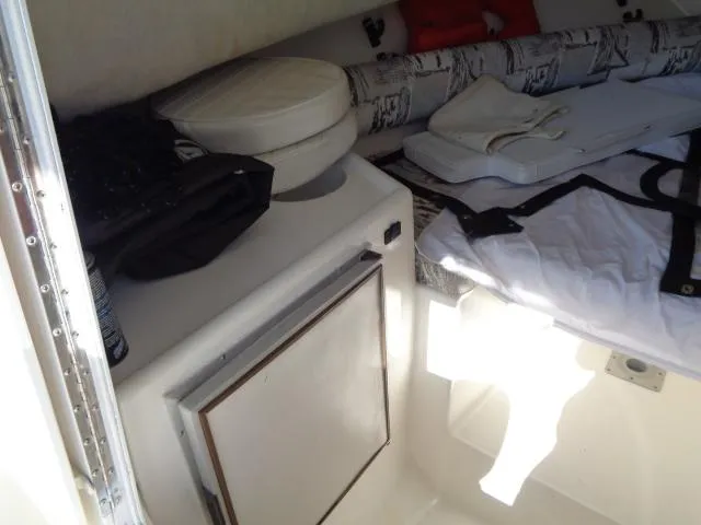 Slide: The Image of Interior cabin of a 2000 Robalo 2240 Walkaround boat with storage and seating. - 29