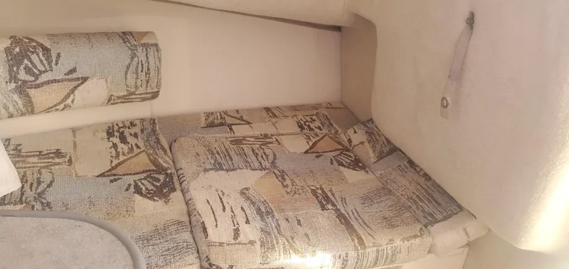 Slide: The Image of Interior cabin of 2000 Robalo 2240 Walkaround boat with patterned cushions. - 32