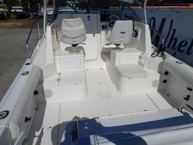 Slide: The Image of 2000 Robalo 2240 Walkaround boat interior with white seating and control console. - 35