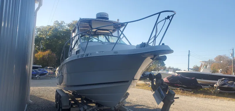 Slide: The Image of 2000 Robalo 2240 Walkaround boat on trailer, parked outdoors. - 6