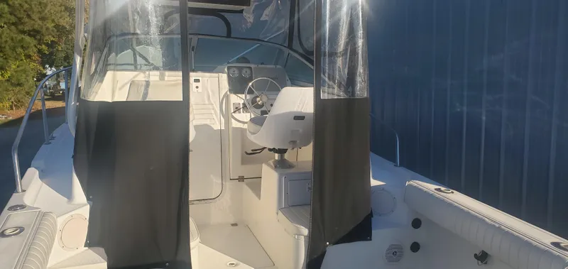 Slide: The Image of 2000 Robalo 2240 Walkaround boat interior with steering wheel and seating. - 7