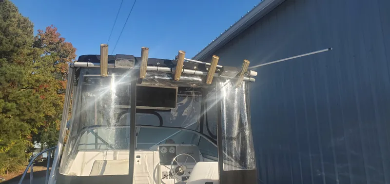 Slide: The Image of 2000 Robalo 2240 Walkaround boat with clear canopy and fishing rod holders. - 8