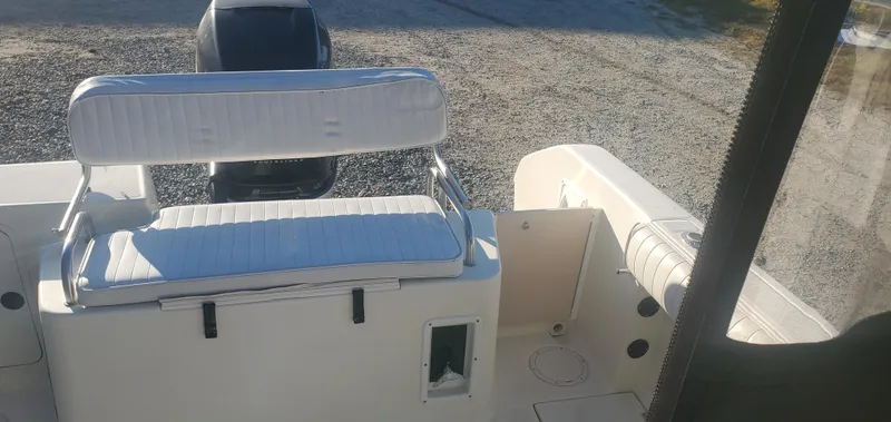 Slide: The Image of 2000 Robalo 2240 Walkaround boat interior with seating and engine view. - 9