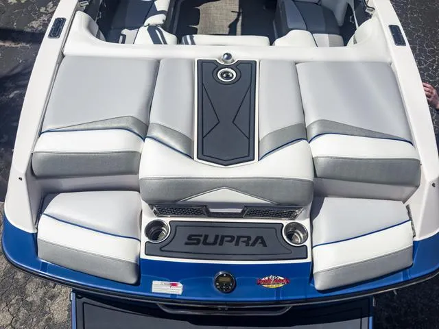 Slide: The Image of 2013 Supra SA 350 boat interior with cushioned seating and storage compartments. - 11