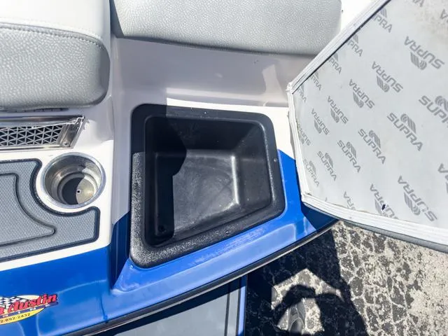 Slide: The Image of 2013 Supra SA 350 boat interior storage compartment and cup holder. - 12