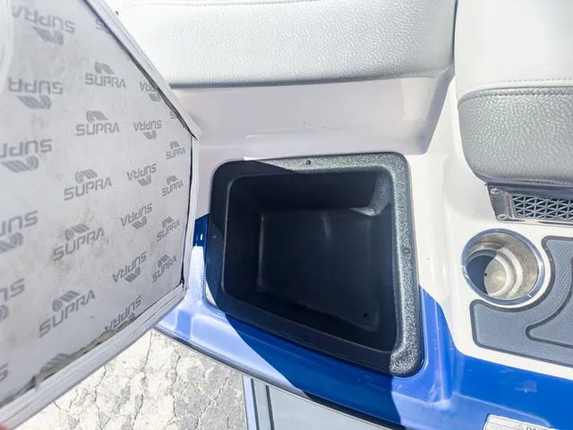 Slide: The Image of 2013 Supra SA 350 boat storage compartment and cup holder. - 14