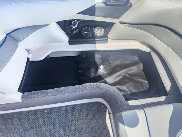 Slide: The Image of 2013 Supra SA 350 boat interior storage compartment with cup holders and speaker. - 19
