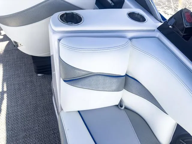 Slide: The Image of 2013 Supra SA 350 boat interior with white and gray seating, cup holders. - 21
