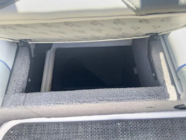 Slide: The Image of Open storage compartment in a 2013 Supra SA 350 boat. - 23