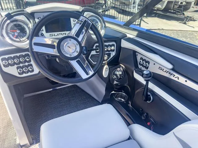 Slide: The Image of 2013 Supra SA 350 boat dashboard with steering wheel and control panel. - 27