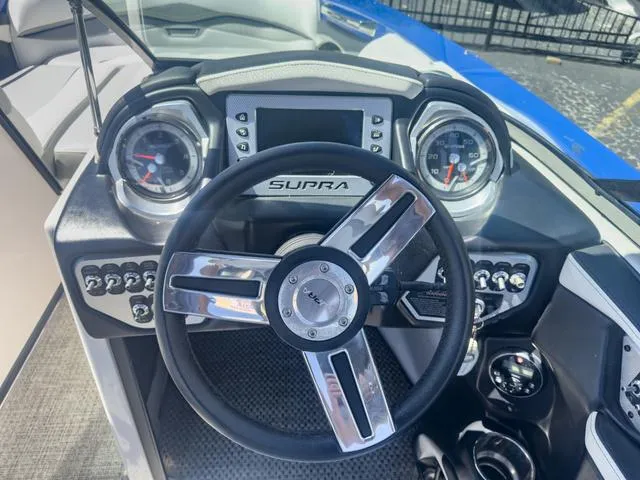 Slide: The Image of 2013 Supra SA 350 boat dashboard with steering wheel and gauges. - 28