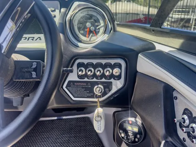 Slide: The Image of Dashboard of a 2013 Supra SA 350 boat with control switches and speedometer. - 30