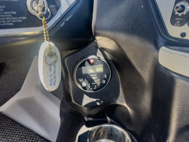 Slide: The Image of Close-up of 2013 Supra SA 350 boat dashboard with ignition key and control panel. - 32