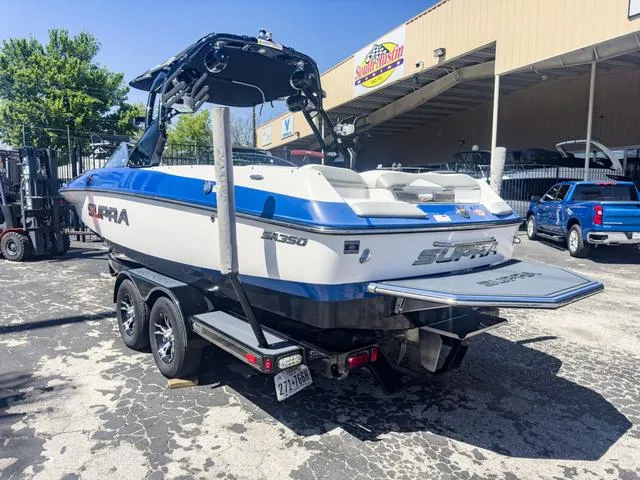 Slide: The Image of 2013 Supra SA 350 boat on a trailer in a parking lot. - 4