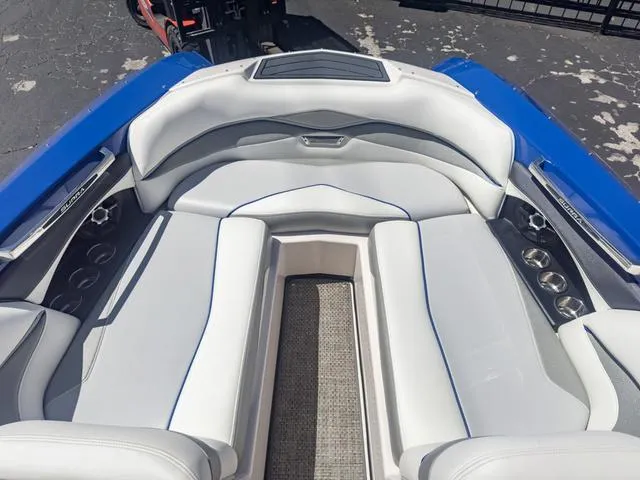Slide: The Image of 2013 Supra SA 350 boat with white and blue interior seating. - 42