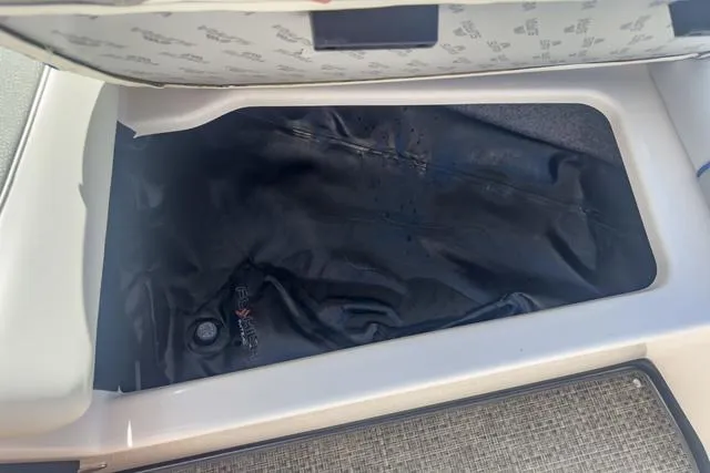 Slide: The Image of Storage compartment of a 2013 Supra SA 350 boat with black cover. - 43