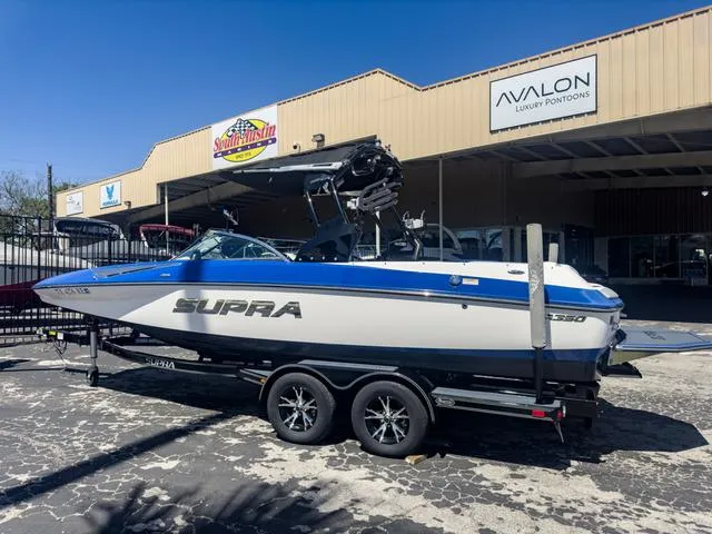 Slide: The Image of 2013 Supra SA 350 boat on a trailer outside a dealership. - 5