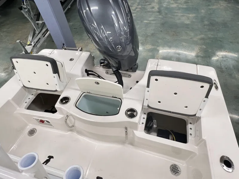 Slide: The Image of 2024 Robalo ROBALO 206 boat interior with storage compartments and outboard motor. - 4