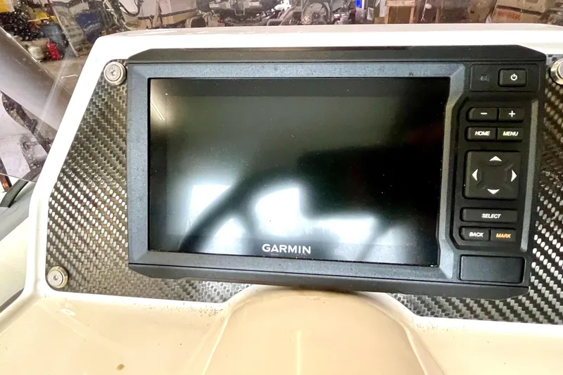 Slide: The Image of Garmin display on 2022 Highfield SP300 boat dashboard with carbon fiber trim. - 7