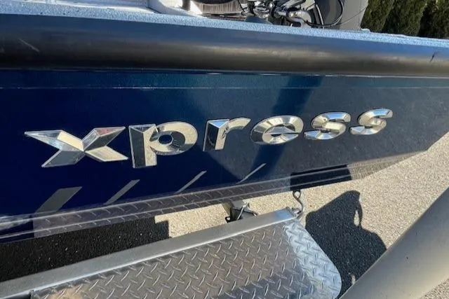 Slide: The Image of 2022 Express XPRESS X19PRO boat with chrome logo and diamond plate step. - 23
