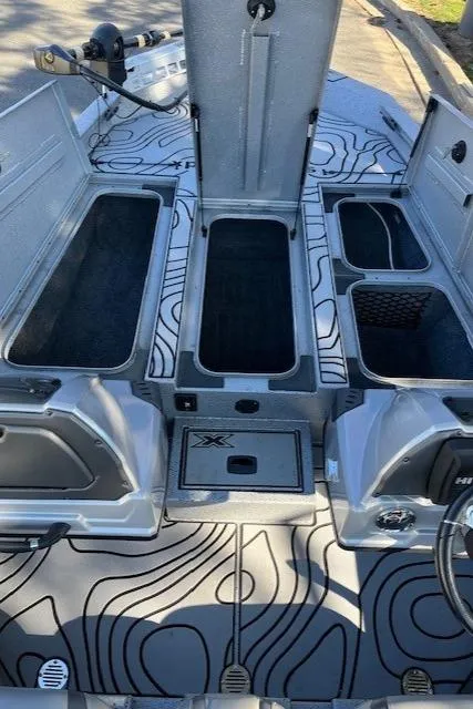 Slide: The Image of 2022 Express XPRESS X19PRO boat interior with open storage compartments. - 8