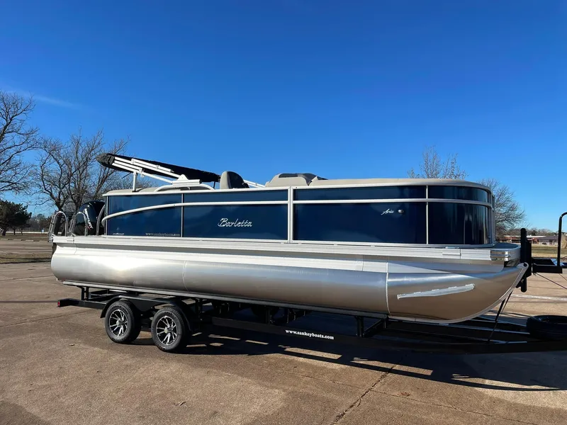 Slide: The Image of 2024 Barletta ARIA 22QC pontoon boat on a trailer in a parking lot. - 15