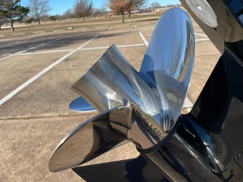 Slide: The Image of Close-up of a 2024 Barletta ARIA 22QC boat propeller in a parking lot. - 18