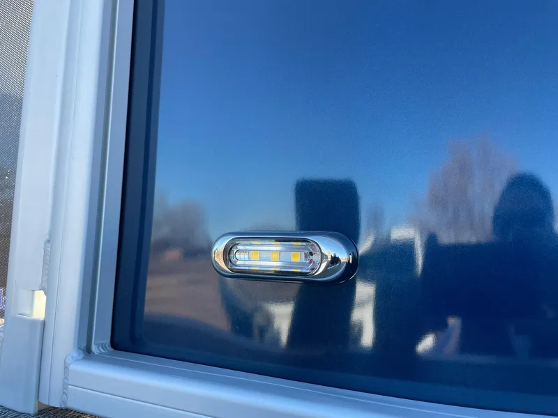 Slide: The Image of Close-up of 2024 Barletta ARIA 22QC exterior LED light. - 24