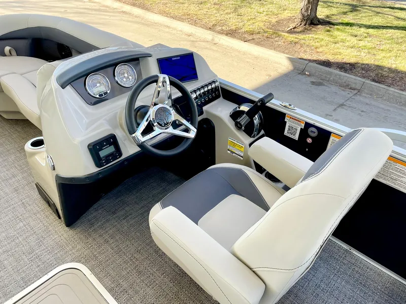 Slide: The Image of 2024 Barletta ARIA 22QC boat cockpit with steering wheel and control panel. - 35