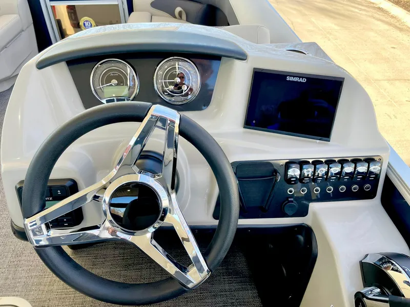 Slide: The Image of 2024 Barletta ARIA 22QC boat dashboard with steering wheel and control panel. - 36