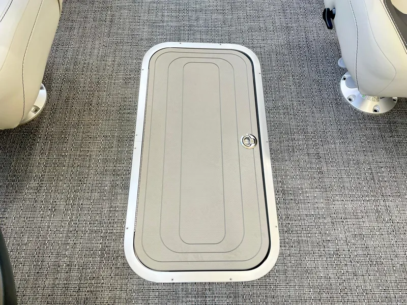 Slide: The Image of 2024 Barletta ARIA 22QC floor storage compartment with gray carpet. - 40