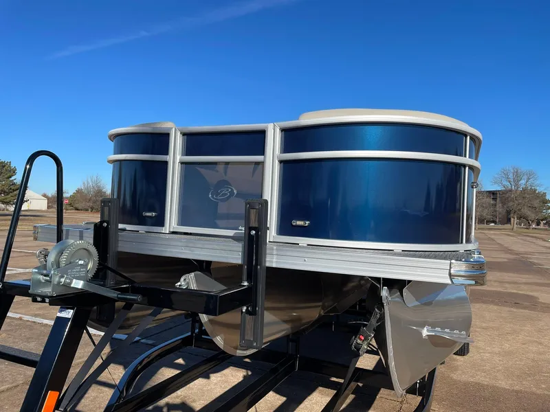 Slide: The Image of 2024 Barletta ARIA 22QC pontoon boat on a trailer under a clear blue sky. - 6