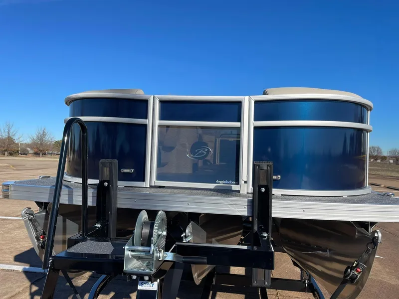 Slide: The Image of 2024 Barletta ARIA 22QC pontoon boat on a trailer under a clear blue sky. - 7