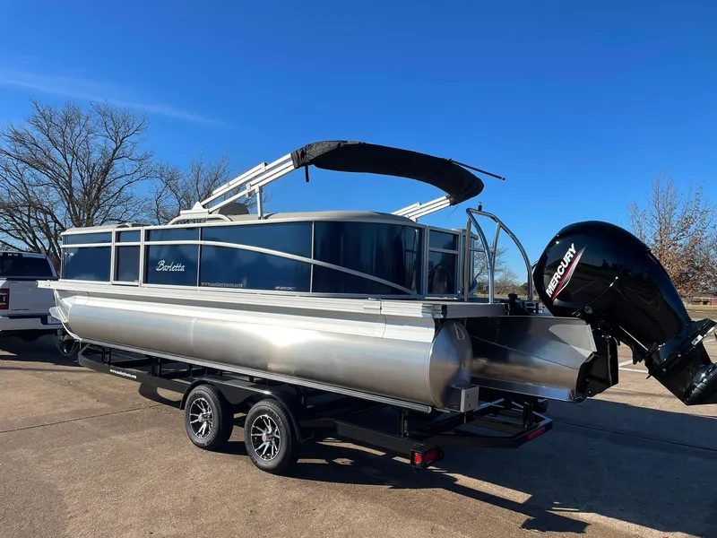 Slide: The Image of 2024 Barletta ARIA 22QC pontoon boat on a trailer with a Mercury outboard motor. - 8